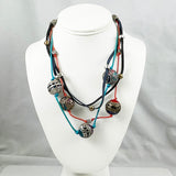 Multicolored Chico's beaded necklace on a white mannequin bust against a gray background