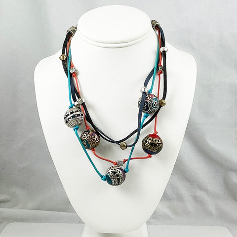 Multicolored Chico's beaded necklace on a white mannequin bust against a gray background