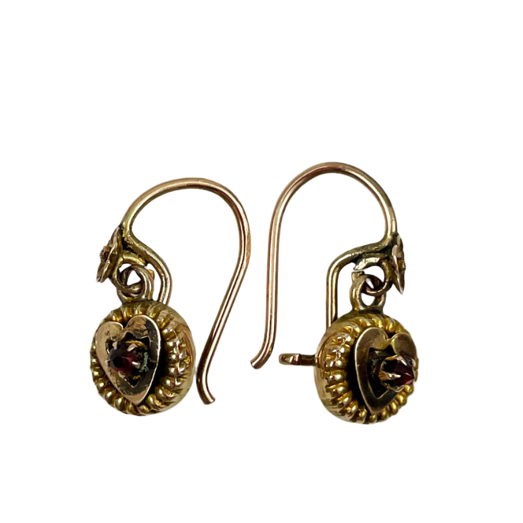 Antique gold earrings with intricate designs on a white background