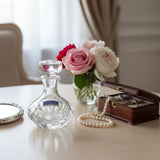 Clear glass candle holder with 'Marquis by Waterford' label on a white surface