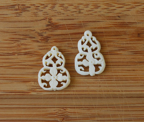 Pair of Pierced & Carved Bone Floral Pendants