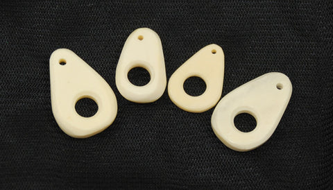 Carved bone eyes for clasps