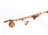 Splendid mid century copper charm bracelet with a gardening theme.