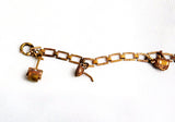 Splendid mid century copper charm bracelet with a gardening theme.