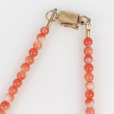 gold clasp on salmon coral necklace